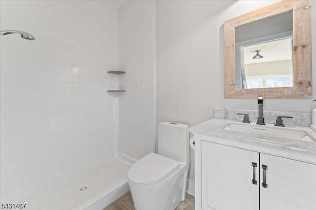 bathroom with vanity, toilet, and walk in shower