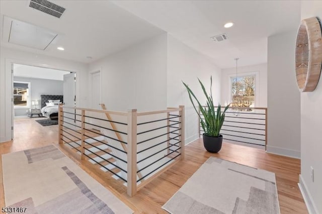 hall with plenty of natural light and light hardwood / wood-style floors