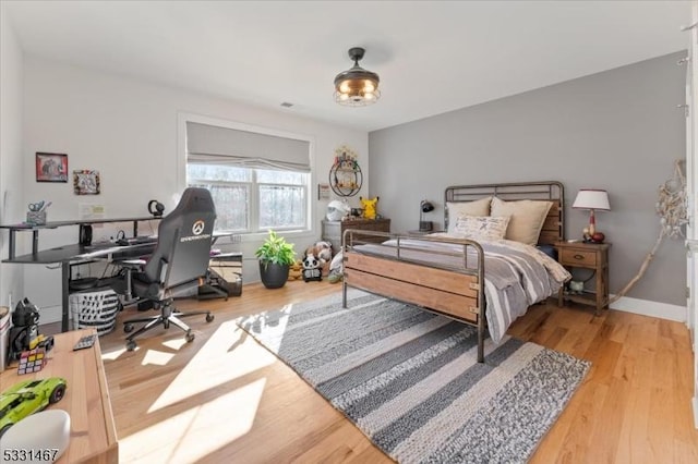 bedroom with hardwood / wood-style floors