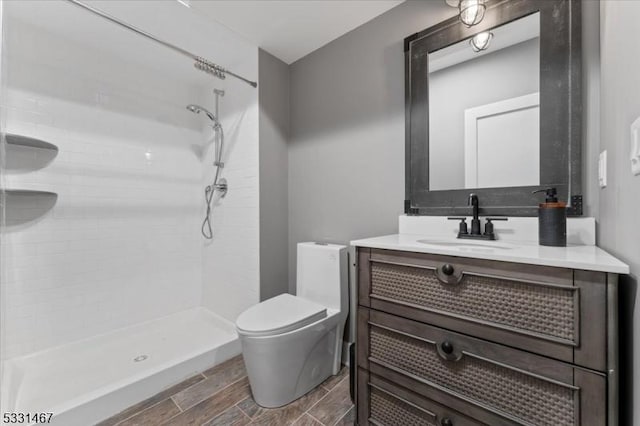 bathroom featuring walk in shower, vanity, and toilet