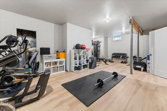 exercise room with hardwood / wood-style flooring