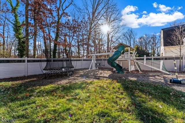 view of yard with a playground and a trampoline