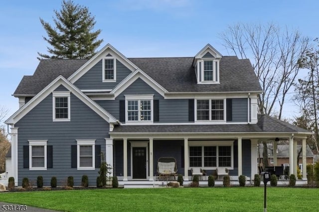 view of front of house with a front yard and covered porch