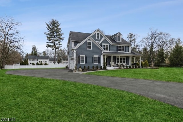 view of front facade with a front yard, a porch, and a garage