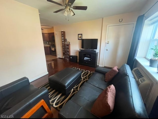 living room with ceiling fan and dark hardwood / wood-style floors