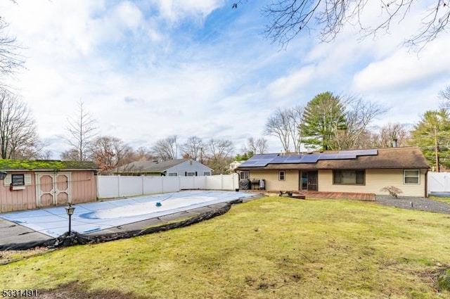 view of yard with a covered pool and a storage shed