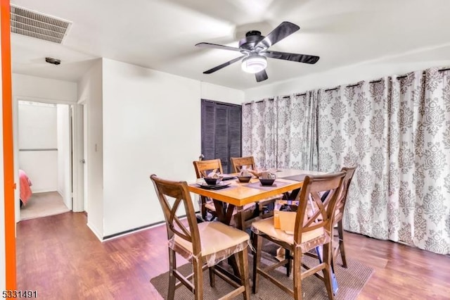 dining area with hardwood / wood-style floors and ceiling fan