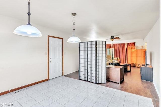 kitchen with decorative light fixtures, ceiling fan, and light tile patterned floors