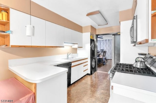 kitchen with gas range, white cabinetry, dishwasher, sink, and kitchen peninsula