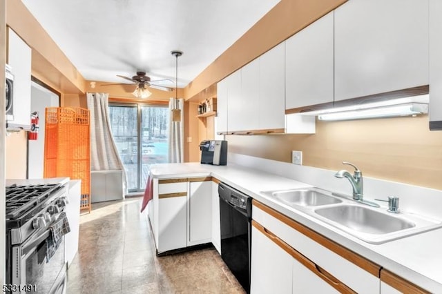 kitchen featuring kitchen peninsula, appliances with stainless steel finishes, sink, pendant lighting, and white cabinets