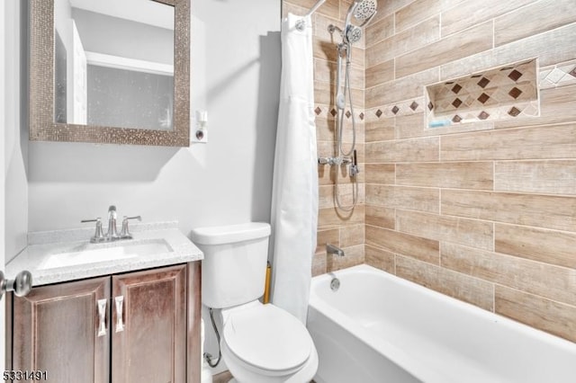 full bathroom with shower / tub combo with curtain, vanity, and toilet