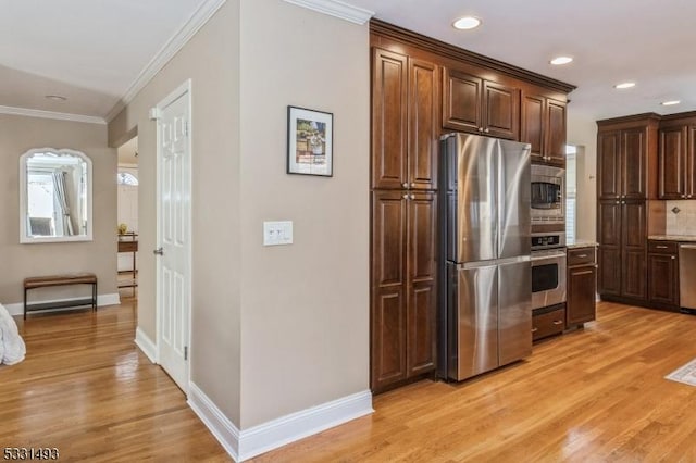 kitchen with decorative backsplash, dark brown cabinetry, stainless steel appliances, and ornamental molding