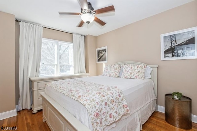 bedroom with ceiling fan and dark hardwood / wood-style flooring