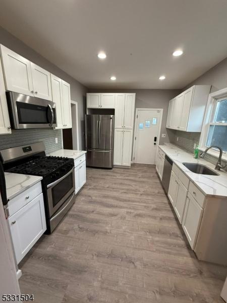 kitchen with white cabinetry and appliances with stainless steel finishes