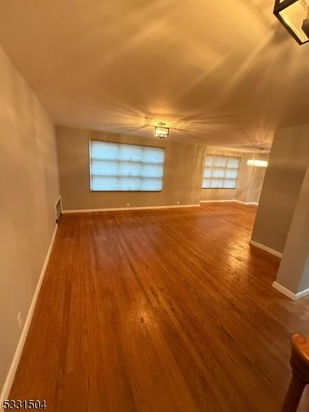 empty room with hardwood / wood-style floors