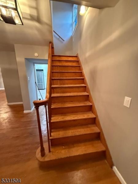 stairs with wood-type flooring