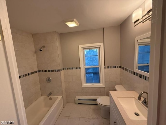 full bathroom featuring baseboard heating, tile patterned floors, toilet, tile walls, and tiled shower / bath