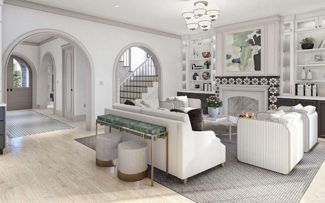 living room with a chandelier, hardwood / wood-style flooring, and ornamental molding