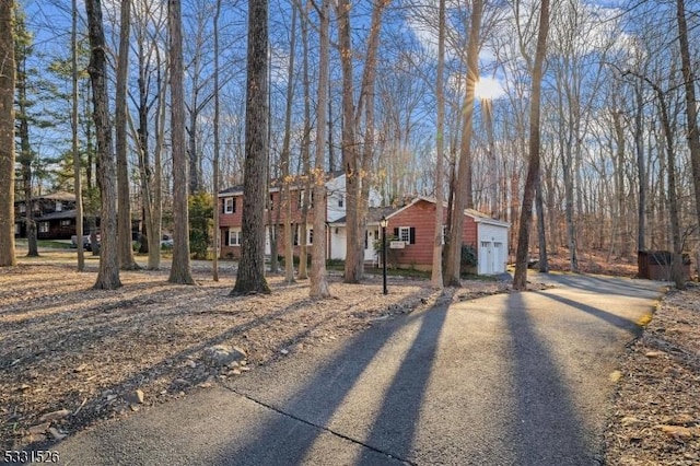 view of front facade with an outbuilding and driveway