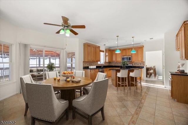 dining room with light tile patterned flooring and ceiling fan