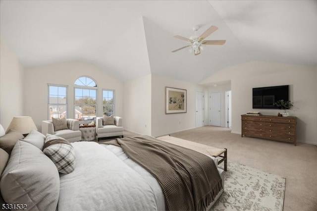 bedroom with ceiling fan, light colored carpet, and vaulted ceiling