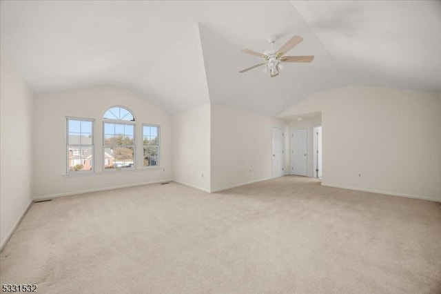 unfurnished living room with lofted ceiling, light carpet, and ceiling fan