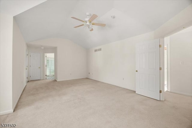 unfurnished room featuring ceiling fan, lofted ceiling, and light carpet