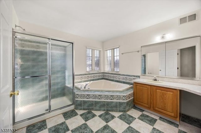 bathroom with vanity and separate shower and tub