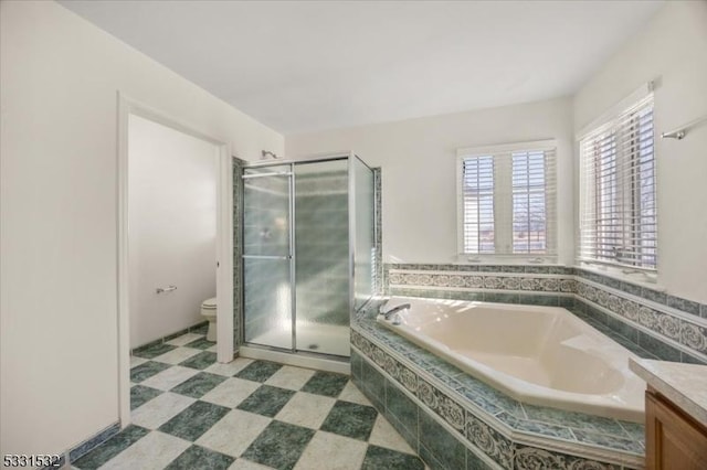 full bathroom with vanity, separate shower and tub, and toilet