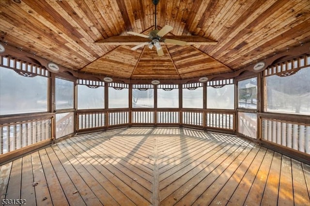 unfurnished sunroom featuring lofted ceiling, wood ceiling, and ceiling fan