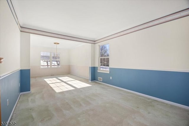 empty room with light colored carpet and ornamental molding