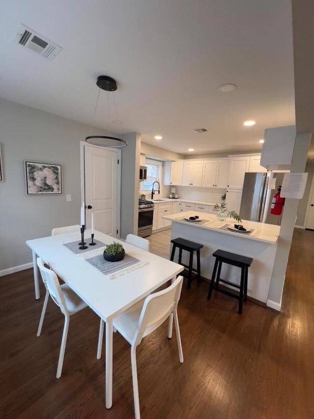 dining area featuring dark hardwood / wood-style flooring and sink