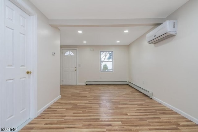 entryway featuring a wall mounted air conditioner, light hardwood / wood-style floors, and baseboard heating