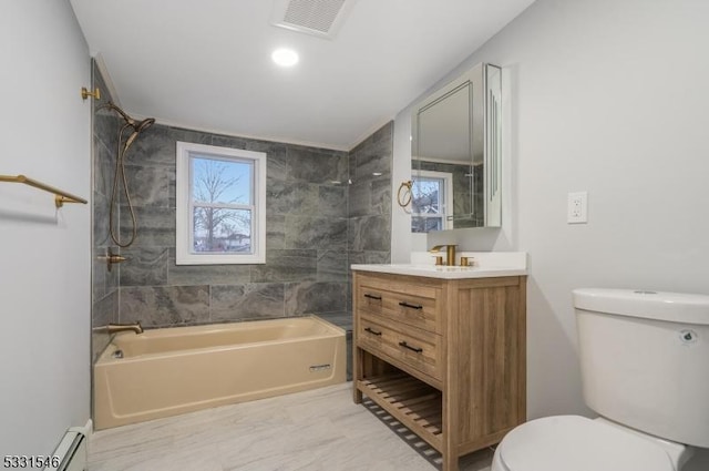 full bathroom with vanity, toilet, and tiled shower / bath