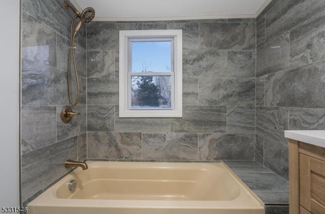 bathroom with vanity and tiled shower / bath