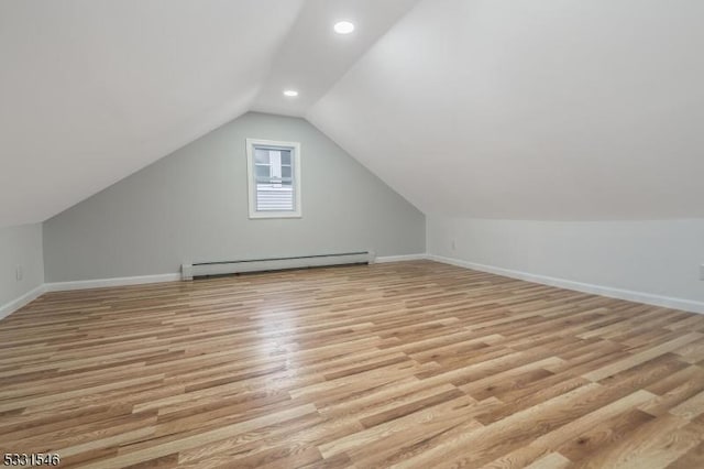 bonus room with lofted ceiling, light wood-type flooring, and baseboard heating