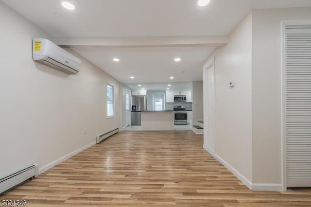 unfurnished living room featuring beamed ceiling, light hardwood / wood-style flooring, a wall unit AC, and a baseboard heating unit