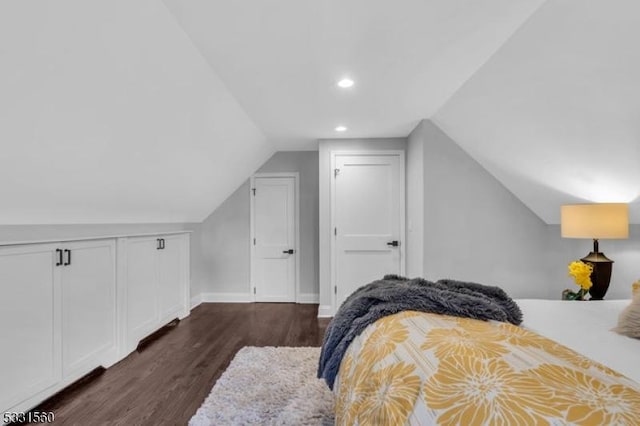 bedroom with dark hardwood / wood-style floors and lofted ceiling