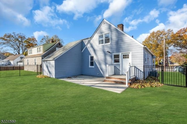 back of house with central AC and a yard