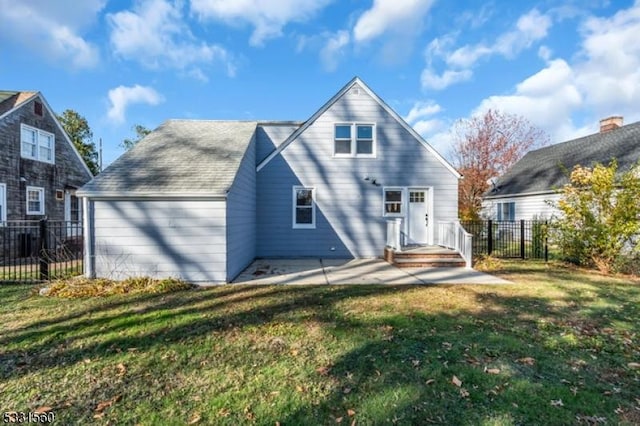 rear view of house featuring a lawn