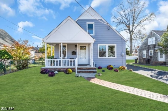 bungalow-style house with a porch and a front lawn