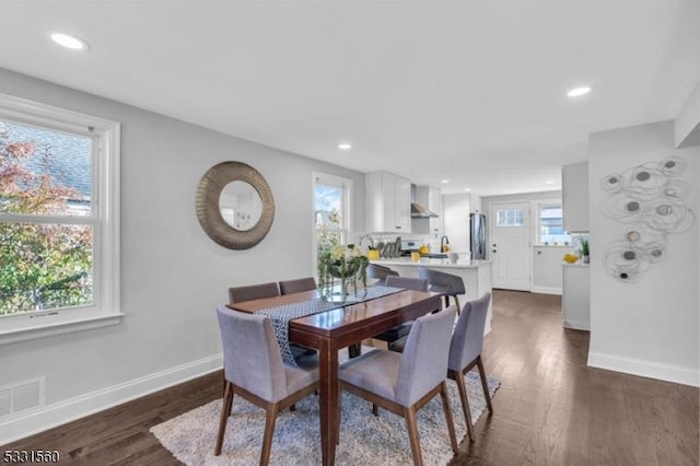 dining space featuring dark hardwood / wood-style floors