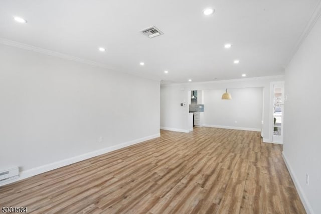 unfurnished living room featuring light hardwood / wood-style floors and crown molding