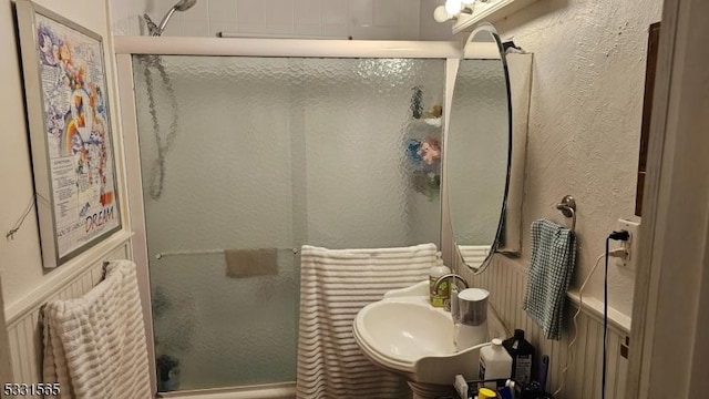 bathroom with walk in shower and sink