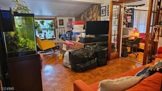 living room with lofted ceiling, french doors, and parquet flooring