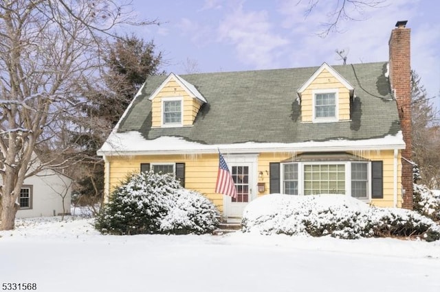 new england style home with a chimney