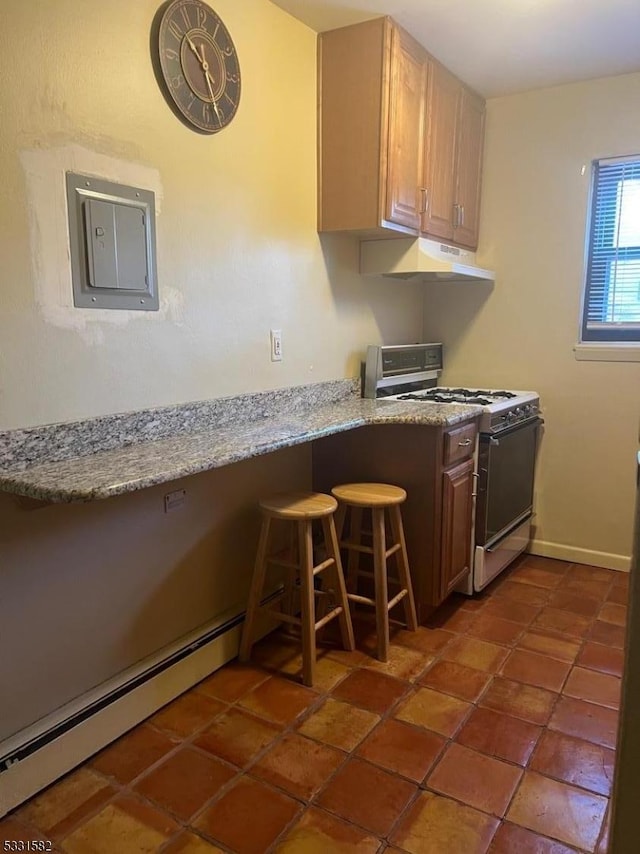 kitchen with a kitchen breakfast bar, white range with gas cooktop, and light stone countertops