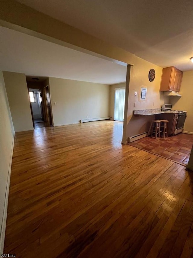 unfurnished living room with a baseboard radiator and dark wood-type flooring