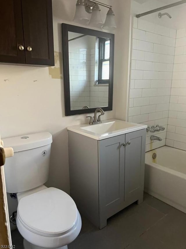 full bathroom with tile patterned flooring, vanity, toilet, and tiled shower / bath