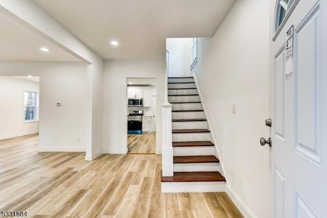 stairs with wood-type flooring